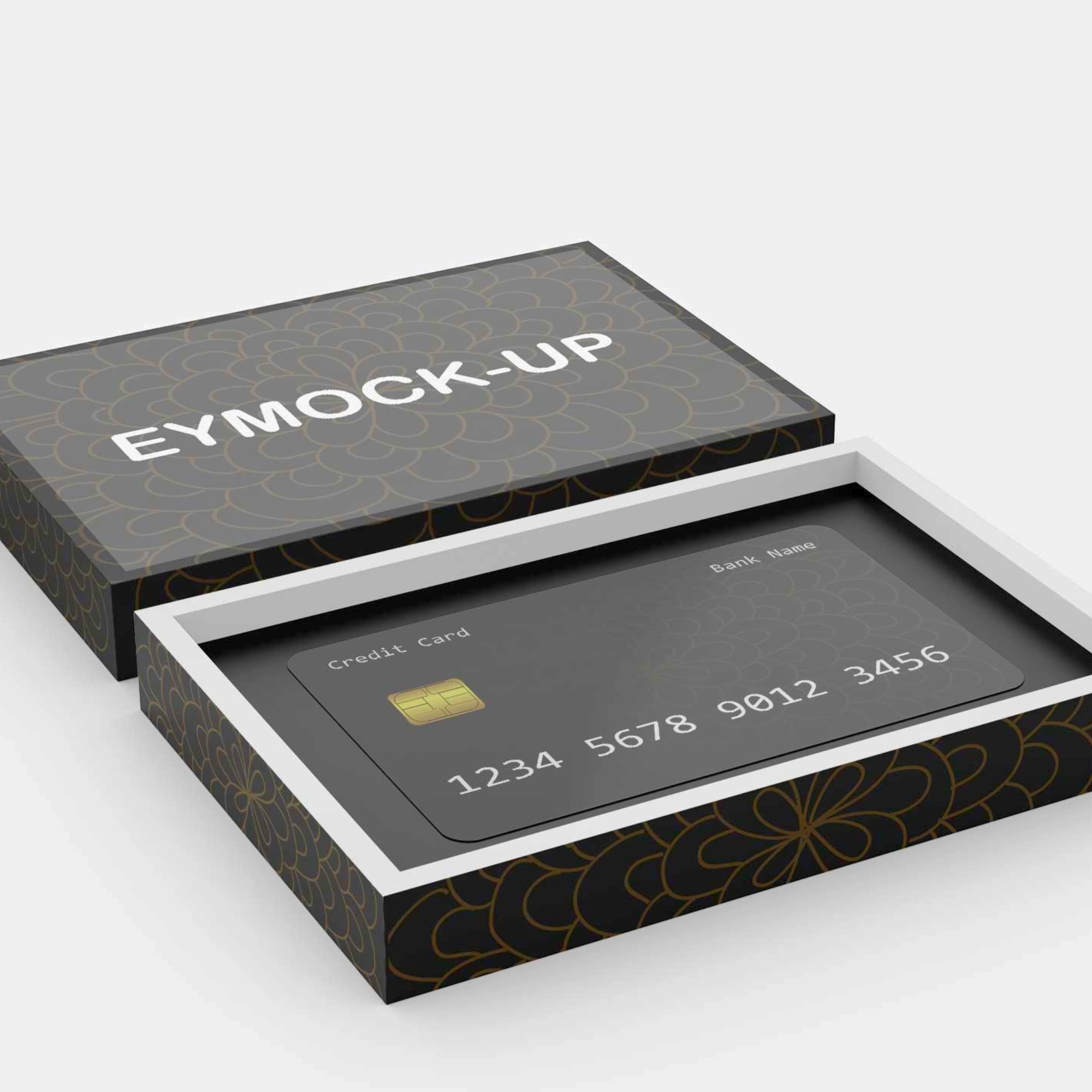 A black business card box with a floral pattern on the side. The lid of the box is open and there is a credit card inside.